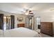 Bright main bedroom features a ceiling fan, ensuite bathroom, and access to outdoor patio at 6614 S Mckemy St, Tempe, AZ 85283