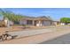 A well-maintained house featuring desert landscaping, a quaint entrance, and a spacious two-car garage at 6926 W Comet Ave, Peoria, AZ 85345