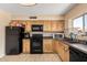 Well-appointed kitchen with wood cabinetry, a tile backsplash, and modern appliances at 6926 W Comet Ave, Peoria, AZ 85345