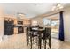 Spacious kitchen features wooden cabinets, tile flooring, and sliding door access to the backyard at 6926 W Comet Ave, Peoria, AZ 85345
