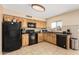 Functional kitchen featuring wood cabinets, tile backsplash, and modern black appliances at 6926 W Comet Ave, Peoria, AZ 85345