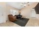Cozy living room featuring a ceiling fan, neutral walls, and tile flooring at 6926 W Comet Ave, Peoria, AZ 85345