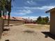 Expansive back yard featuring desert landscaping, privacy fence, and blue sky at 7702 W Piute Ave, Glendale, AZ 85308