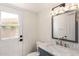 Bathroom featuring marble countertop, vanity, toilet and door to the exterior at 7702 W Piute Ave, Glendale, AZ 85308