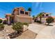 Two-story home featuring a spacious driveway and well-maintained desert landscaping at 7702 W Piute Ave, Glendale, AZ 85308