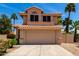 Two-story home featuring a tile roof, attached garage, and low-maintenance landscaping at 7702 W Piute Ave, Glendale, AZ 85308