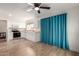 Kitchen with white cabinets, laminate countertops, stainless steel appliances, and ceiling fan at 7702 W Piute Ave, Glendale, AZ 85308