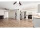 Open-concept kitchen boasts stainless steel appliances and adjacent fireplace in the living area at 7702 W Piute Ave, Glendale, AZ 85308