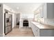 Kitchen boasts white cabinets, laminate countertops, and stainless steel appliances at 7702 W Piute Ave, Glendale, AZ 85308
