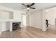 Bright and open living room features a fireplace, hardwood floors, and modern design elements at 7702 W Piute Ave, Glendale, AZ 85308