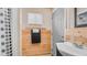 Compact bathroom with wood paneled walls, a sink, and ample lighting, maximizing space and functionality at 838 Aquamarine Dr, Apache Junction, AZ 85119