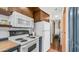 A look at the kitchen featuring appliances, dark cabinetry, wood countertops, and wood-style floors at 838 Aquamarine Dr, Apache Junction, AZ 85119