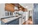 Kitchen featuring bright-white appliances, wood floors, a window, dark cabinetry, and wood countertops at 838 Aquamarine Dr, Apache Junction, AZ 85119