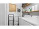 Well-equipped laundry room with washer, dryer, shelving and convenient organizational features for efficient chore management at 838 Aquamarine Dr, Apache Junction, AZ 85119