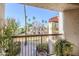 View of a balcony with plants overlooking the community landscaping with palm trees at 9275 E Mission Ln # 206, Scottsdale, AZ 85258