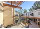 View of the balcony with a wooden pergola, metal cactus decoration and plants at 9275 E Mission Ln # 206, Scottsdale, AZ 85258