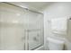 Bright bathroom featuring a tiled shower with sliding glass doors and a white toilet at 9275 E Mission Ln # 206, Scottsdale, AZ 85258