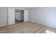 Bedroom featuring laminate flooring and access to another room through white double doors at 9275 E Mission Ln # 206, Scottsdale, AZ 85258