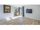 Spacious bedroom with laminate flooring, TV, and sliding glass door to balcony at 9275 E Mission Ln # 206, Scottsdale, AZ 85258