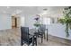 Bright dining area with modern table, stylish chairs, and easy access to the kitchen with stainless steel appliances at 9275 E Mission Ln # 206, Scottsdale, AZ 85258