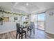 Cozy dining area featuring a modern table set, a decorative mirror, and sliding doors leading to the outside at 9275 E Mission Ln # 206, Scottsdale, AZ 85258