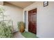 Welcoming front entrance with a stylish door, lush potted plant, and a view of the well-maintained exterior at 9275 E Mission Ln # 206, Scottsdale, AZ 85258