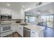 Bright kitchen featuring white cabinets, stainless steel appliances, and an island perfect for food prep and entertaining at 9275 E Mission Ln # 206, Scottsdale, AZ 85258