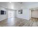 Bright living room with laminate flooring, sliding doors to balcony, and ample storage at 9275 E Mission Ln # 206, Scottsdale, AZ 85258