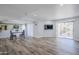 Spacious living room with laminate flooring, sliding doors to balcony, and ample natural light at 9275 E Mission Ln # 206, Scottsdale, AZ 85258