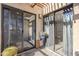 Enclosed patio area with stone flooring, sliding glass doors, and potted plants at 9275 E Mission Ln # 206, Scottsdale, AZ 85258
