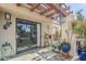 Covered patio featuring tile flooring, decorative plants, and sliding glass doors at 9275 E Mission Ln # 206, Scottsdale, AZ 85258