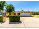 Charming yellow single-story home boasts a well-maintained front yard and attached two car garage at 9714 N 55Th Dr, Glendale, AZ 85302