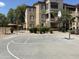 Condominiums building view from paved basketball court and hoop with beautiful landscaping and nearby palm trees at 10136 E Southern Ave # 1052, Mesa, AZ 85209