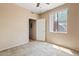 Bedroom with neutral carpet, a ceiling fan, a closet, and a window at 10136 E Southern Ave # 1052, Mesa, AZ 85209