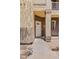 Inviting front entrance with pathway leading to a white door, adorned with address number at 10136 E Southern Ave # 1052, Mesa, AZ 85209