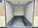 Clean, empty garage ready for parking and storage with garage door and opener at 10136 E Southern Ave # 1052, Mesa, AZ 85209