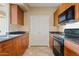 Kitchen features wood cabinets, stone countertops, and a pantry at 10136 E Southern Ave # 1052, Mesa, AZ 85209
