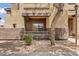 View of the covered patio with exterior wall and desert landscaping with decorative rocks at 10136 E Southern Ave # 1052, Mesa, AZ 85209