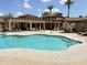 Resort-style swimming pool with lounge chairs and shaded seating areas, surrounded by beautiful landscaping at 10136 E Southern Ave # 1052, Mesa, AZ 85209