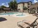 Community pool area with chaise lounges, sunshades, spa and lush landscaping at 10136 E Southern Ave # 1052, Mesa, AZ 85209