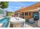 The outdoor space features a large fire bar, grill, seating, and sliding glass doors to the home's interior at 10838 N 10Th St, Phoenix, AZ 85020