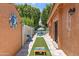 Backyard features artificial turf, cornhole boards, and a view of the pool at 10838 N 10Th St, Phoenix, AZ 85020