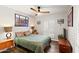 Bedroom featuring a ceiling fan, shutters on the windows, and neutral color scheme at 10838 N 10Th St, Phoenix, AZ 85020