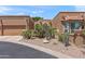 Exterior view of the desert-landscaped home, showcasing garage and tile roof at 10838 N 10Th St, Phoenix, AZ 85020