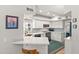Well-lit kitchen featuring white cabinetry, stainless steel appliances, and sleek countertops at 10838 N 10Th St, Phoenix, AZ 85020