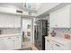 Bright kitchen with updated appliances, clean white cabinetry, and a modern stainless steel refrigerator at 10838 N 10Th St, Phoenix, AZ 85020