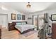 Bright main bedroom with patio access, modern light fixture, and decorative wall art at 10838 N 10Th St, Phoenix, AZ 85020