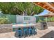 Outdoor bar with seating, BBQ, and landscaped backyard at 10838 N 10Th St, Phoenix, AZ 85020