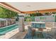 Backyard featuring an in-ground pool, covered patio with a bar, and landscaping at 10838 N 10Th St, Phoenix, AZ 85020