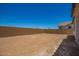 Large backyard with dirt and block wall for privacy at 11408 S 50Th Ln, Laveen, AZ 85339